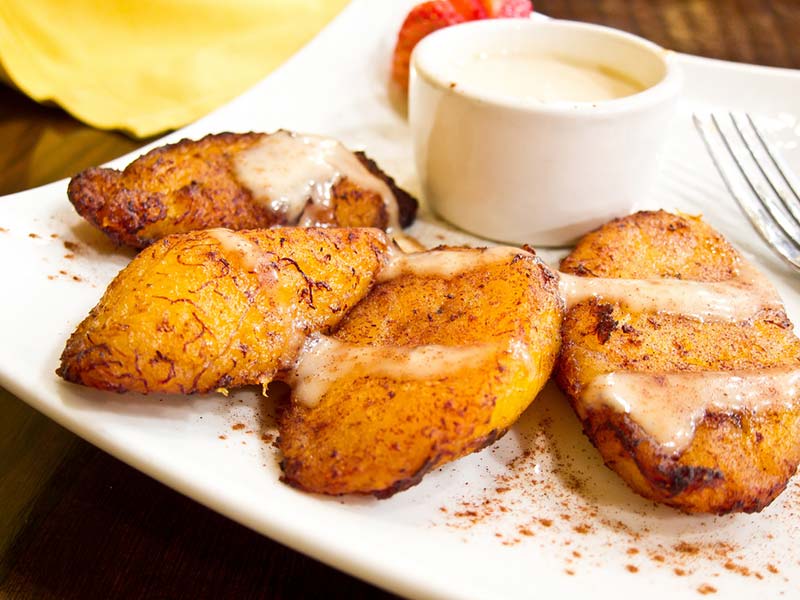 A plate of fried plantain with dipping source