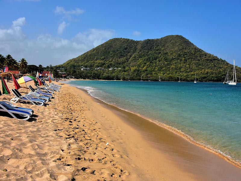 A view of Reduit Beach facing south with beach chairs and umbrellas for guests.