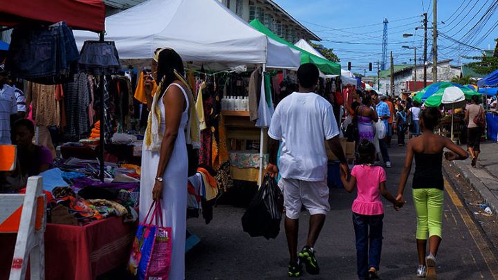 Customers browse flea market stalls at the castries market.